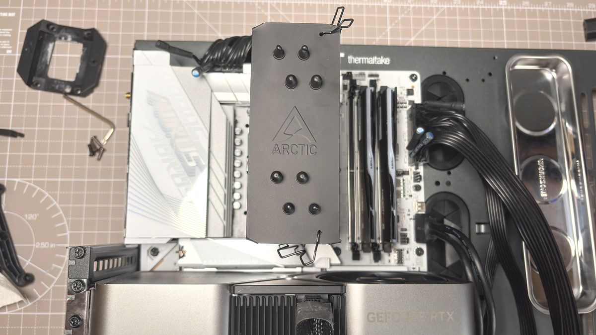 An Arctic Freezer 36-S on a desk and installed in a gaming PC, with the Freezer 36 nearby.