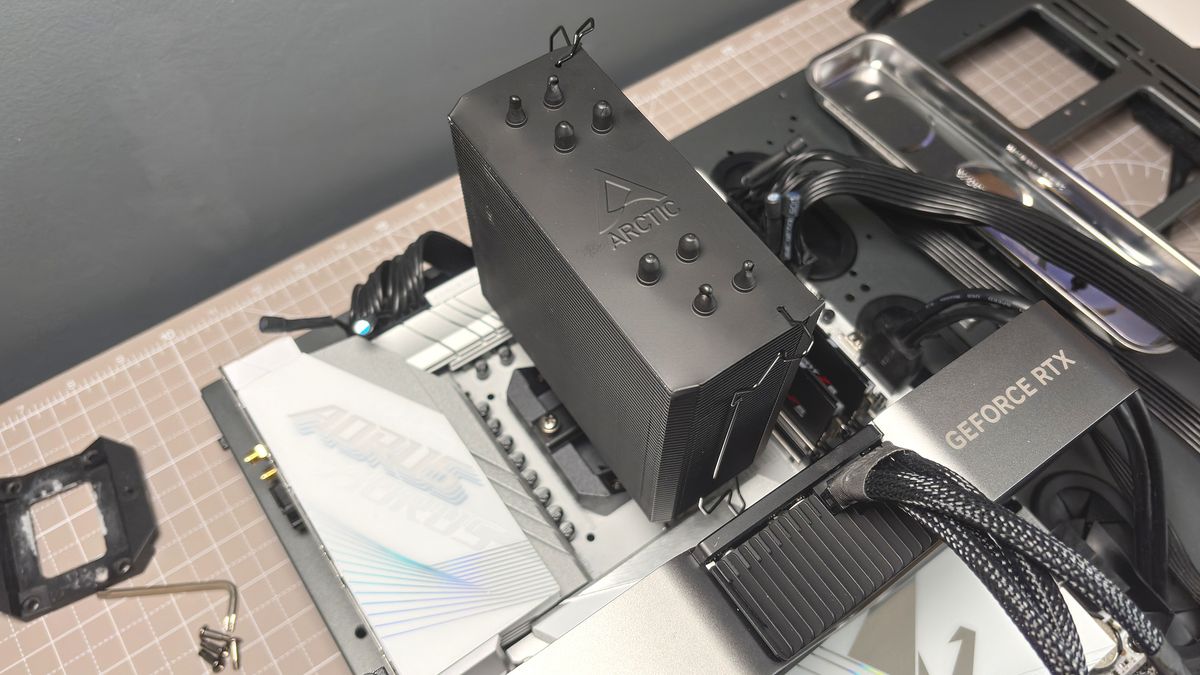 An Arctic Freezer 36-S on a desk and installed in a gaming PC, with the Freezer 36 nearby.