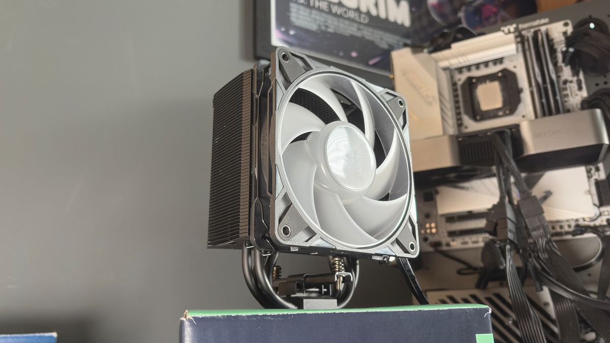 An Arctic Freezer 36-S on a desk and installed in a gaming PC, with the Freezer 36 nearby.