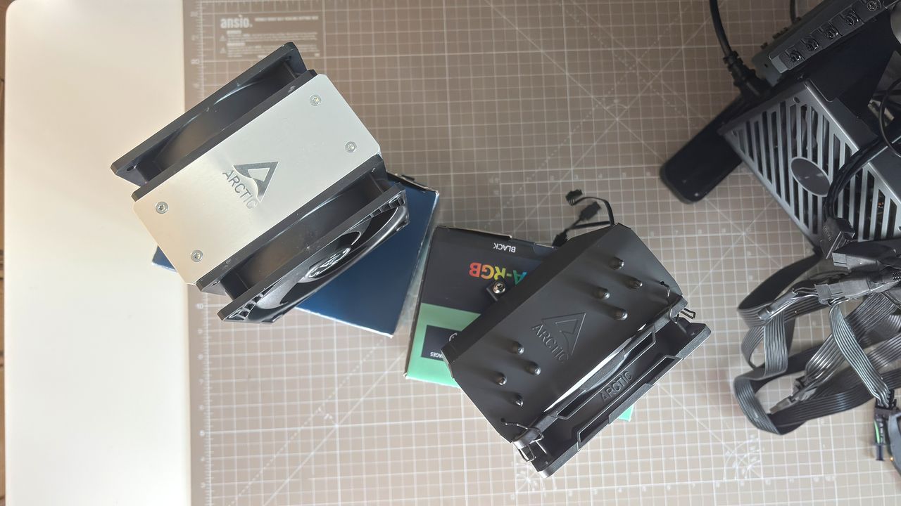 An Arctic Freezer 36-S on a desk and installed in a gaming PC, with the Freezer 36 nearby.