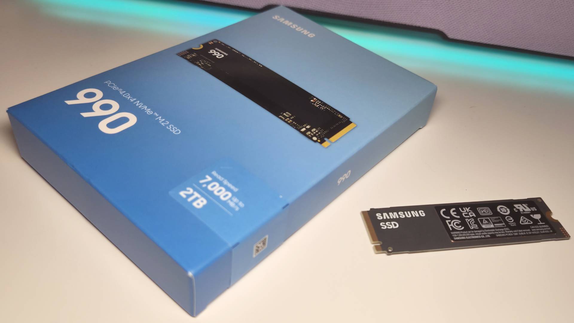 Photo of the Samsung 990 SSD sitting next to its box.