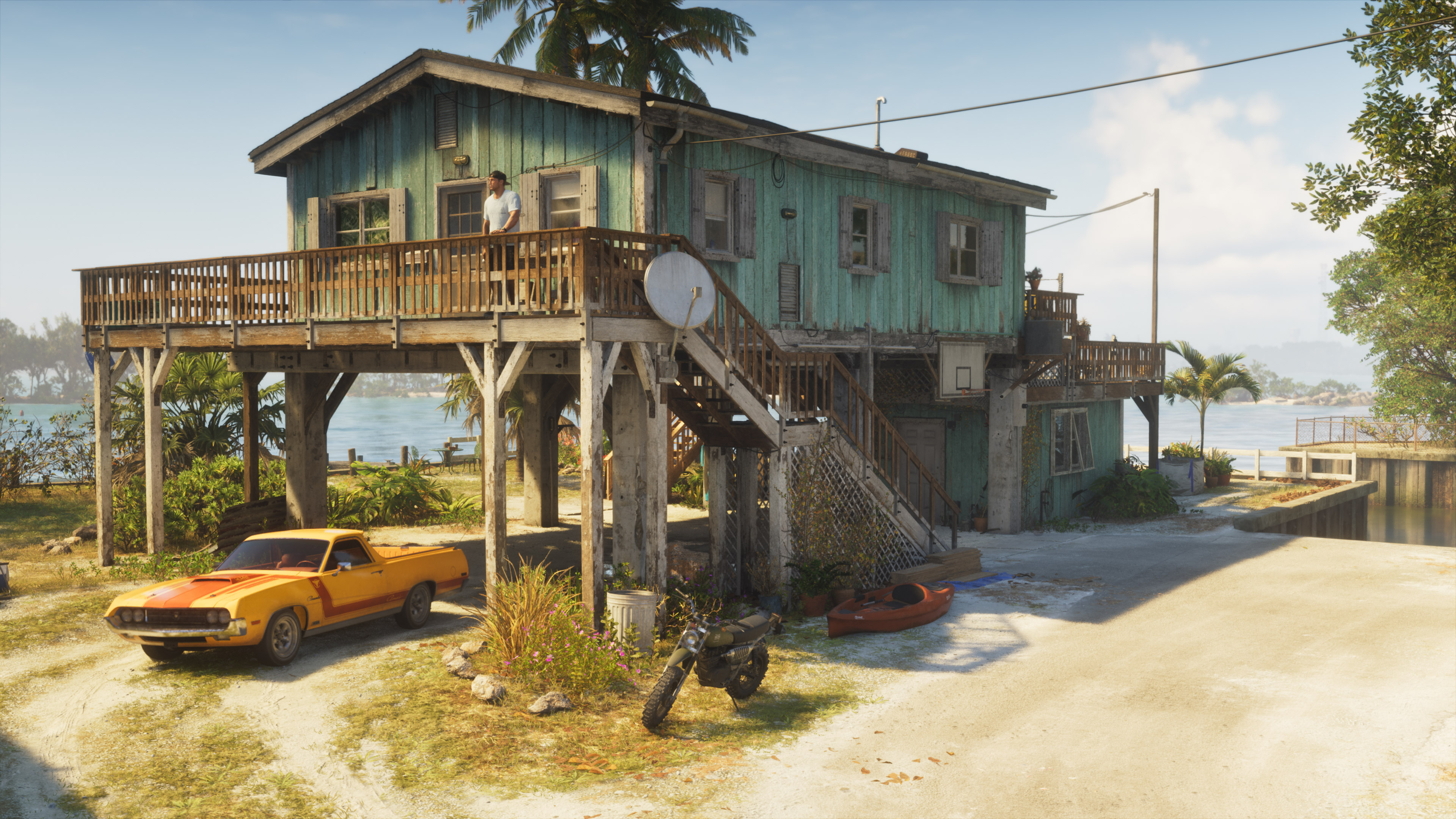 Beach house with car and motorbike.
