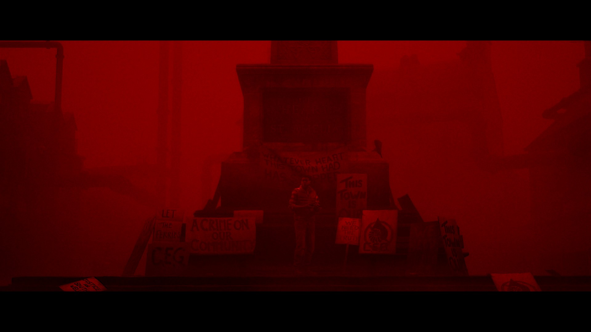 A town statue in Silent Hill Townfall is cast in a stark red light